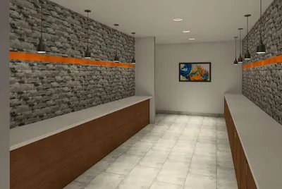 a waiting room with a brick wall at La Quinta Inn & Suites by Wyndham Littleton-Red Rocks in Littleton