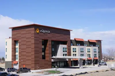 a hotel with aania sign on the front of a building at La Quinta Inn & Suites by Wyndham Littleton-Red Rocks in Littleton
