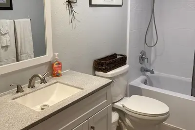a bathroom with a sink and a toilet and a tub at Twin Rivers 3 in Fraser