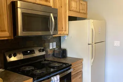 a kitchen with a stove and a refrigerator at Twin Rivers 3 in Fraser