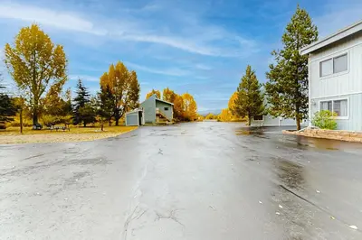an empty street with a building and trees at Twin Rivers 3 in Fraser