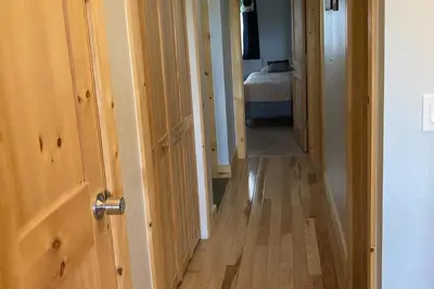 a hallway with an open door to a bedroom at Twin Rivers 3 in Fraser