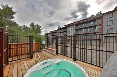 a hot tub on the deck of a balcony at Timber Run Evergreen 9 in Winter Park
