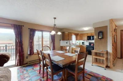 a kitchen and dining room with a table and chairs at Timber Run Evergreen 9 in Winter Park