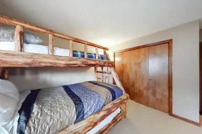 a bedroom with two bunk beds and a closet at Timber Run Evergreen 9 in Winter Park