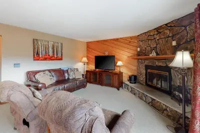a living room with a couch and a fireplace at Timber Run Evergreen 9 in Winter Park