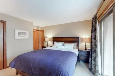 a bedroom with a large bed and a window at Timber Run Evergreen 9 in Winter Park