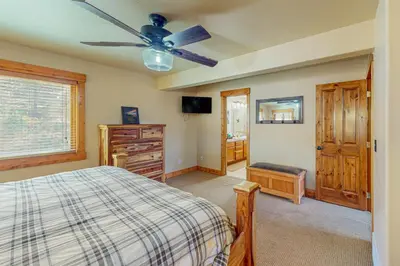 a bedroom with a bed and a ceiling fan at Spruce Chalet in Granby