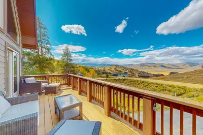 a balcony with a view of the mountains at Spruce Chalet in Granby