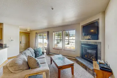 a living room with a couch and a fireplace at Arrowhead 31 in Fraser