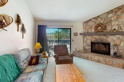 a living room with a couch and a fireplace at MeadowRidge 13-04 in Fraser
