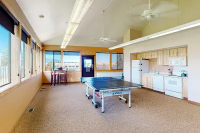 a kitchen with a ping pong table in a room at MeadowRidge 13-04 in Fraser