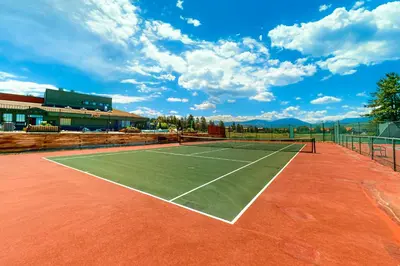 a tennis court with a tennis racket on it at MeadowRidge 13-04 in Fraser