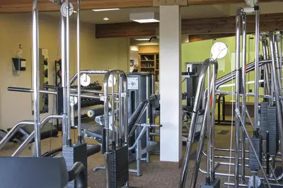 a gym with rows of treadmills and machines at MeadowRidge 13-04 in Fraser