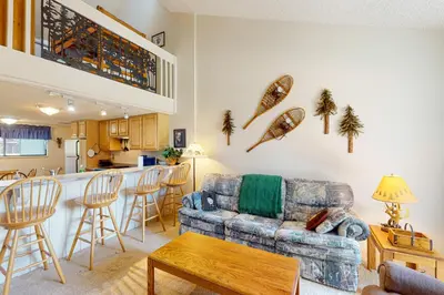 a living room with a couch and a kitchen at MeadowRidge 13-04 in Fraser