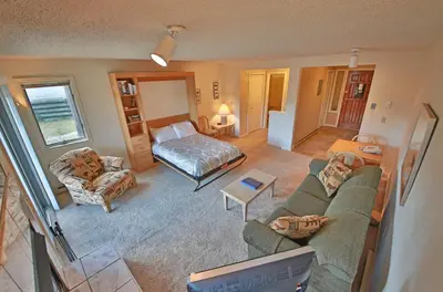 a living room with a couch and a bed at Timber Run Vista 2 in Winter Park