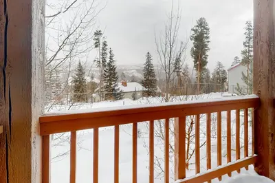 a snow covered balcony with a view of a yard at Timber Run Vista 2 in Winter Park