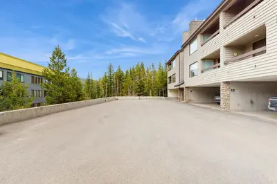 an empty parking lot in front of a building at Snowblaze Condominiums E103 in Winter Park