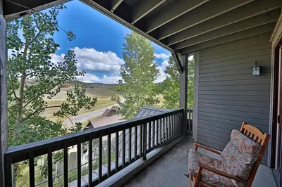 a balcony with a chair and a view at Kicking Horse Lodges 3-202 in Granby
