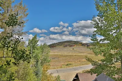 a view of a field with a hill in the distance at Kicking Horse Lodges 3-202 in Granby