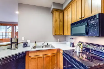 a kitchen with a sink and a microwave at Kicking Horse Lodges 3-202 in Granby