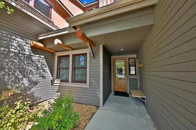 a front door of a house with a porch at Kicking Horse Lodges 3-202 in Granby