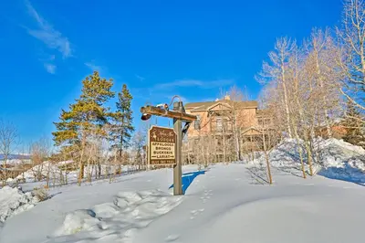 a sign in the snow in front of a building at Kicking Horse Lodges 3-202 in Granby