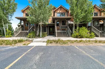 a large house with a road in front of it at Kicking Horse Lodges 4-205 in Granby
