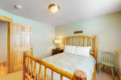 a bedroom with a bed with a wooden head board at Sunset Chalet in Tabernash