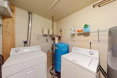 a laundry room with a washer and dryer at Sunset Chalet in Tabernash