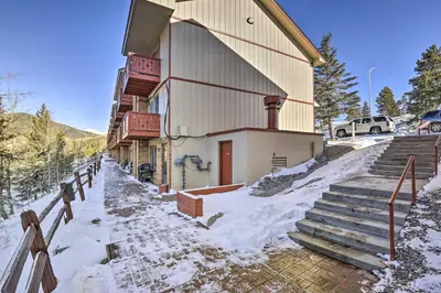 a house with snow on the ground next to a fence at 7 Mi to Keystone Mtn-View Abode with Deck! in Dillon