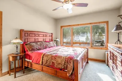 a bedroom with a bed and a window at Tranquility On The River Three -- EV #6042 townhouse in Estes Park