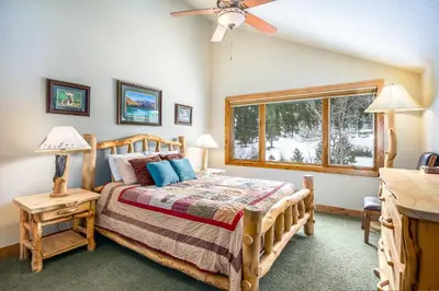 a bedroom with a bed and a window at Tranquility On The River Four -- EV #6041 townhouse in Estes Park