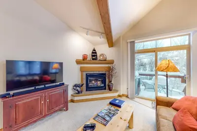 a living room with a fireplace and a television at Blue River Townhome Unit D6 in Silverthorne