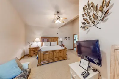 a bedroom with a bed and a flat screen tv at Blue River Townhome Unit D6 in Silverthorne