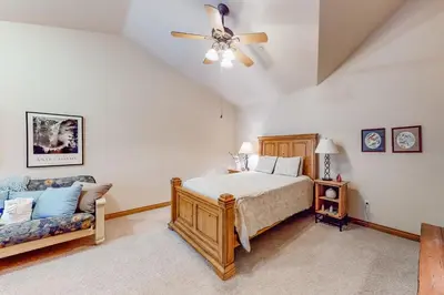 a bedroom with a bed and a couch at Blue River Townhome Unit D6 in Silverthorne