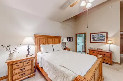 a bedroom with a bed and a dresser and a lamp at Blue River Townhome Unit D6 in Silverthorne