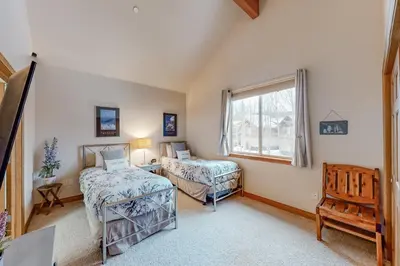 a bedroom with two beds and a window at Blue River Townhome Unit D6 in Silverthorne