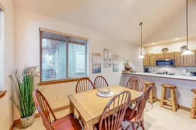 a kitchen and dining room with a wooden table and chairs at Blue River Townhome Unit D6 in Silverthorne