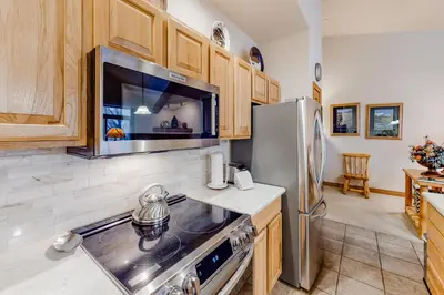 a kitchen with a stove and a refrigerator at Blue River Townhome Unit D6 in Silverthorne