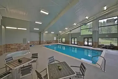 a large pool with tables and chairs in a building at Hi Country Haus Getaway in Winter Park