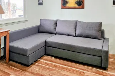 a gray couch sitting in a living room at Hi Country Haus Getaway in Winter Park