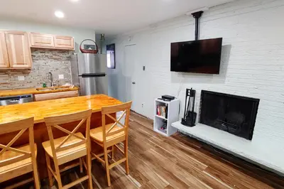 a kitchen with a wooden table and a fireplace at Hi Country Haus Getaway in Winter Park