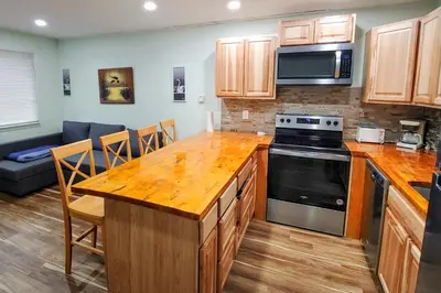a kitchen with a wooden counter top and a stove top oven at Hi Country Haus Getaway in Winter Park