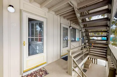 a house with a staircase next to a door at Hi Country Haus Getaway in Winter Park