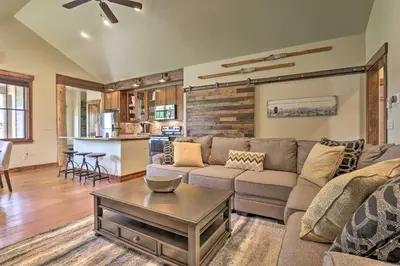 a living room with a couch and a table at Walk to Main St and Marina Grand Lake Cabin! in Grand Lake
