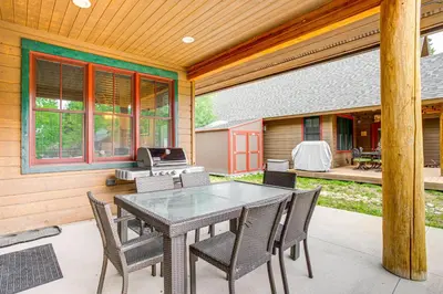 a patio with a table and chairs on a house at Walk to Main St and Marina Grand Lake Cabin! in Grand Lake