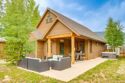 a log home with a patio with couches at Walk to Main St and Marina Grand Lake Cabin! in Grand Lake
