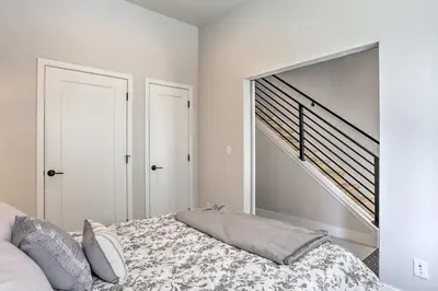 a bedroom with a bed with a large mirror at Trendy Denver Townhome - Walk to Mile High Stadium in Denver