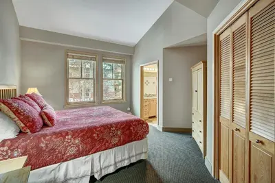 a bedroom with a red bed and a window at River Run Village by Vail Resorts in Keystone